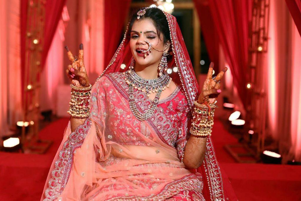 Udaipur Bride Posing in a wedding wearing red saree